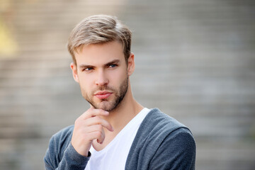 Young millennial man outdoor. Stylish man portrait. Casual style of man. Guy has stylish hair. Man...