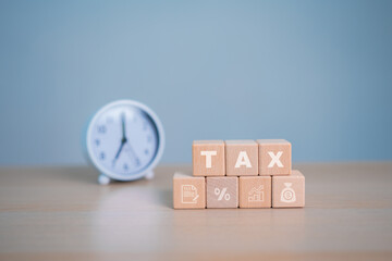 Tax icon in the wooden cube for income tax return and submit tax for payment tax documents online.