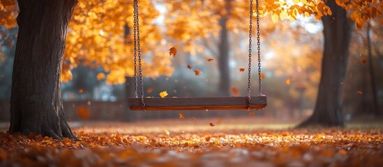 A wooden swing hangs from a tree in a golden autumn forest, leaves falling around it.