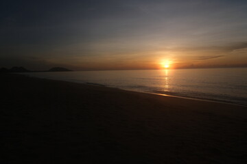 The sun rises at the sea in the morning.