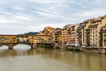 Ponte Vecchio, old bridge on the river in Florence with dramatic sky