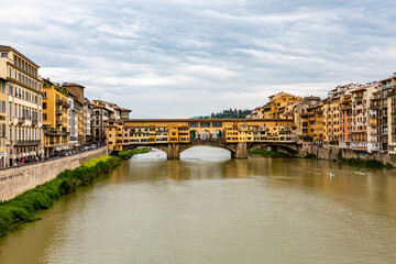 Fototapeta premium Ponte Vecchio, old bridge on the river in Florence with dramatic sky