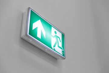 exit sign, green sign, emergency exit, safety sign, public signage, building safety, evacuation route, emergency signage, safety indication, wayfinding, directional sign, exit marker