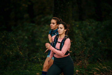The two sportswomen running on the road