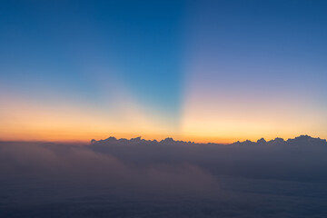 Heaven at early morning with copy space. Sunset, sunrise backdrop.Predawn clear sky with Winter landscape morning mist. Smooth orange blue gradient of dawn sky.