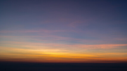Heaven at early morning with copy space. Sunset, sunrise backdrop.Predawn clear sky with orange horizon and blue atmosphere. Smooth orange blue gradient of dawn sky.