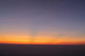 Obraz premium Heaven at early morning with copy space. Sunset, sunrise backdrop.Predawn clear sky with orange horizon and blue atmosphere. Smooth orange blue gradient of dawn sky.