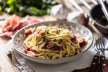 Traditional Italian spaghetti with prosciutto, mushrooms and parmesan
