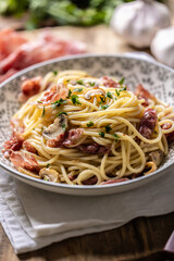 Traditional Italian spaghetti with prosciutto, mushrooms and parmesan