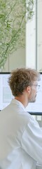 Fototapeta premium Focused Male Scientist Analyzing Data in Modern Laboratory Setting