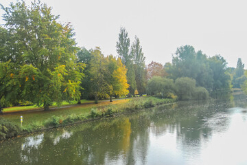 Autumn time in a park in the UK with a river in the image.