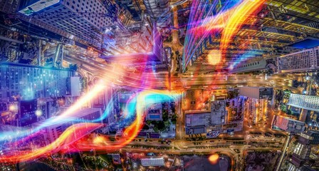 An aerial view of a Hong Kong city at night, illuminated by street lights and colorful lights reflecting off buildings.