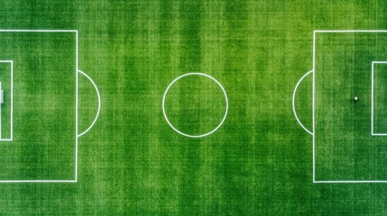 Aerial drone view of an empty green soccer field with white boundary lines and markings a few players training in one corner deep depth of field perspective outdoor sports and recreation concept
