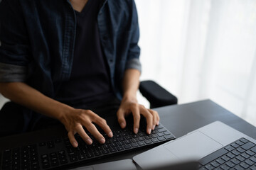 Asian man software engineer Working on Computer at office desk for writing program code IT Software...