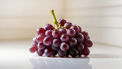 A tight shot of grapes with dewdrops on their surfaces.