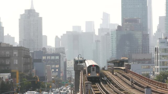 New York subway station. Metro train, metropolitan platform, United States public transportation. Elevated outdoor railway, 7 line, Queens. NYC passenger railroad traffic. Manhattan, Empire State view