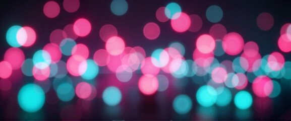 Colorful bokeh lights in pink and teal against dark background