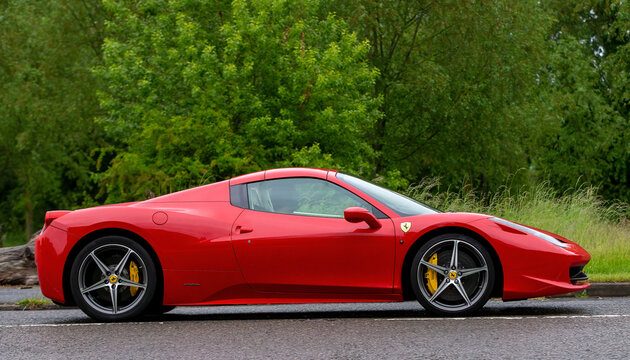 Red Ferrari 458 in profile car