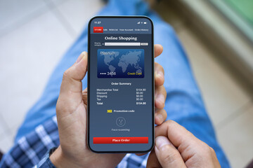 male hands holding phone with online shopping app on screen