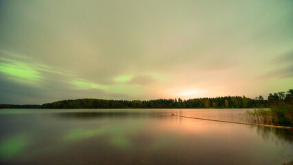 color photo with beautiful northern lights in the sky, northern lights over the lake