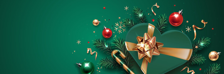 Horizontal banner with gold, green and red Christmas symbols and place for text. Christmas tree, gift, balls, golden tinsel confetti and snowflakes on a green background. Luxury background.
