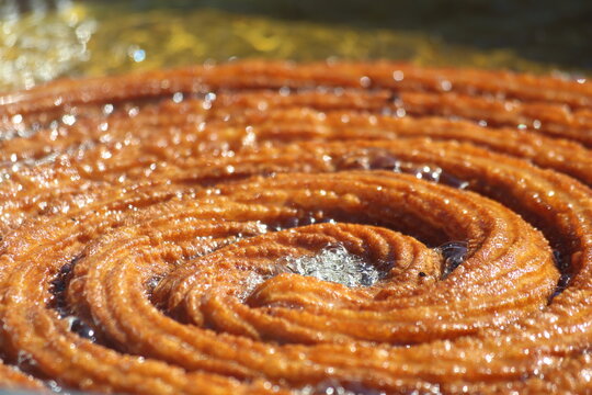 giant spiral Turkish dessert being deep fried