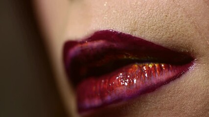Beauty lipstick. Makeup with red lips macro. Beautiful young woman applying lipstick on lips. Lip gloss closeup. cosmetics for female lips. Applying with lipstick. Young woman applying red lipstick on
