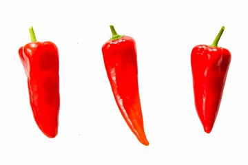 Three red bell peppers isolated on white.