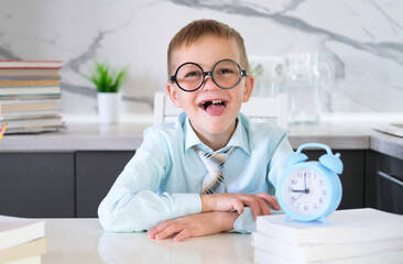 Happy kid in tie and shirt is messing around with schoolwork. Concept of teaching and educational...