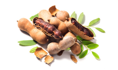 Tamarind tropical fruits isolated on white background. Fresh Tamarind pods with leaves (Tamarindus indica, Indian date), healthy vegan food close up. 