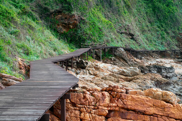 A wooden bridge on the edge of a rocky mountainside