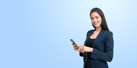 Young woman finger touch smartphone, smiling on empty blue background