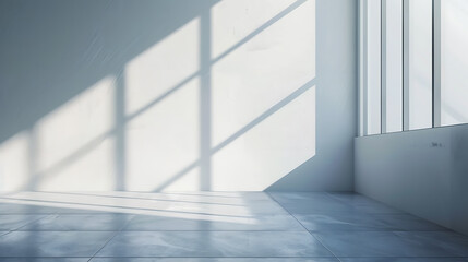 Obraz premium Sunlight streams through a large window, casting geometric shadows on the white wall of a minimalist room.