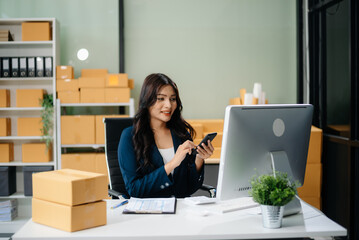 Businesswoman handling packaging and logistics in a modern workspace, managing e-commerce orders efficiently