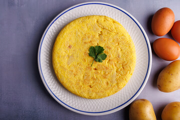 Colorful Spanish Omelette on Gray-Blue Concrete Table