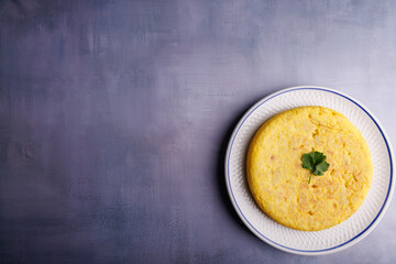 Spanish Potato Omelette on Blue Concrete Table