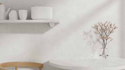 A round white dining table with a vase, a wooden armchair, and a wall shelf displaying kitchenware.
