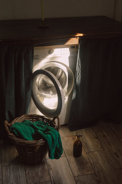 Sunlight over washing machine near laundry basket