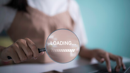 Woman holding Magnifying glass with futuristic loading progress bar interface, depicting data processing or software installation concept. Digital loading information