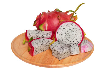 isolated dragon fruit on wooden plate