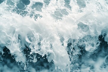 Fototapeta premium A magnificent ocean wave surging forward with powerful splashes and a trail of white spray, demonstrating the sheer force and beauty of the sea.