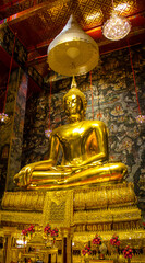 A large gilded Buddha statue, Luang Pho To, Wat Kalyanimit, Bangkok, Thailand, is sacred and highly revered by the people.