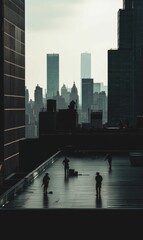 Obraz premium Silhouetted figures stand on rooftop overlooking city.