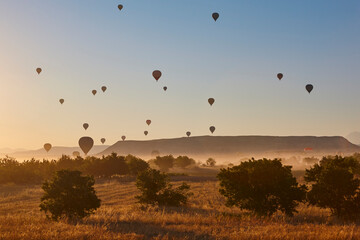 Balloons at dusk in Cappadocia. Famous flight in Goreme. Turkey