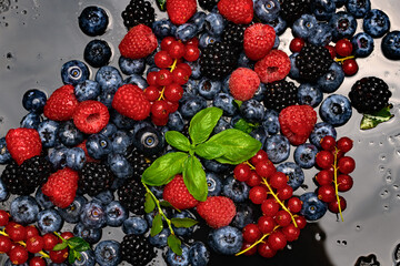 Berry background. Texture of fresh wild berries. Garden berry. Summer berry fruit. Raspberry, blueberry, blackberry.