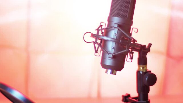 An audio technician turns off a professional microphone. Disconnecting the cable from the socket.
