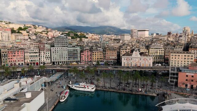 The vibrant waterfront of Porto Antico in Genoa, Italy, with boats and historic buildings