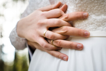 A pair of newlyweds holding hands.
