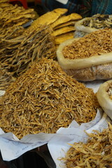 Mixed dried fish are displayed and sold at a fish market, Different types of dried fish are sold by a street vendor, All types of dried salted fish in the Asian biggest seafood market