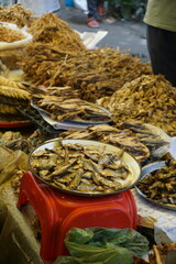 Mixed dried fish are displayed and sold at a fish market, Different types of dried fish are sold by a street vendor, All types of dried salted fish in the Asian biggest seafood market